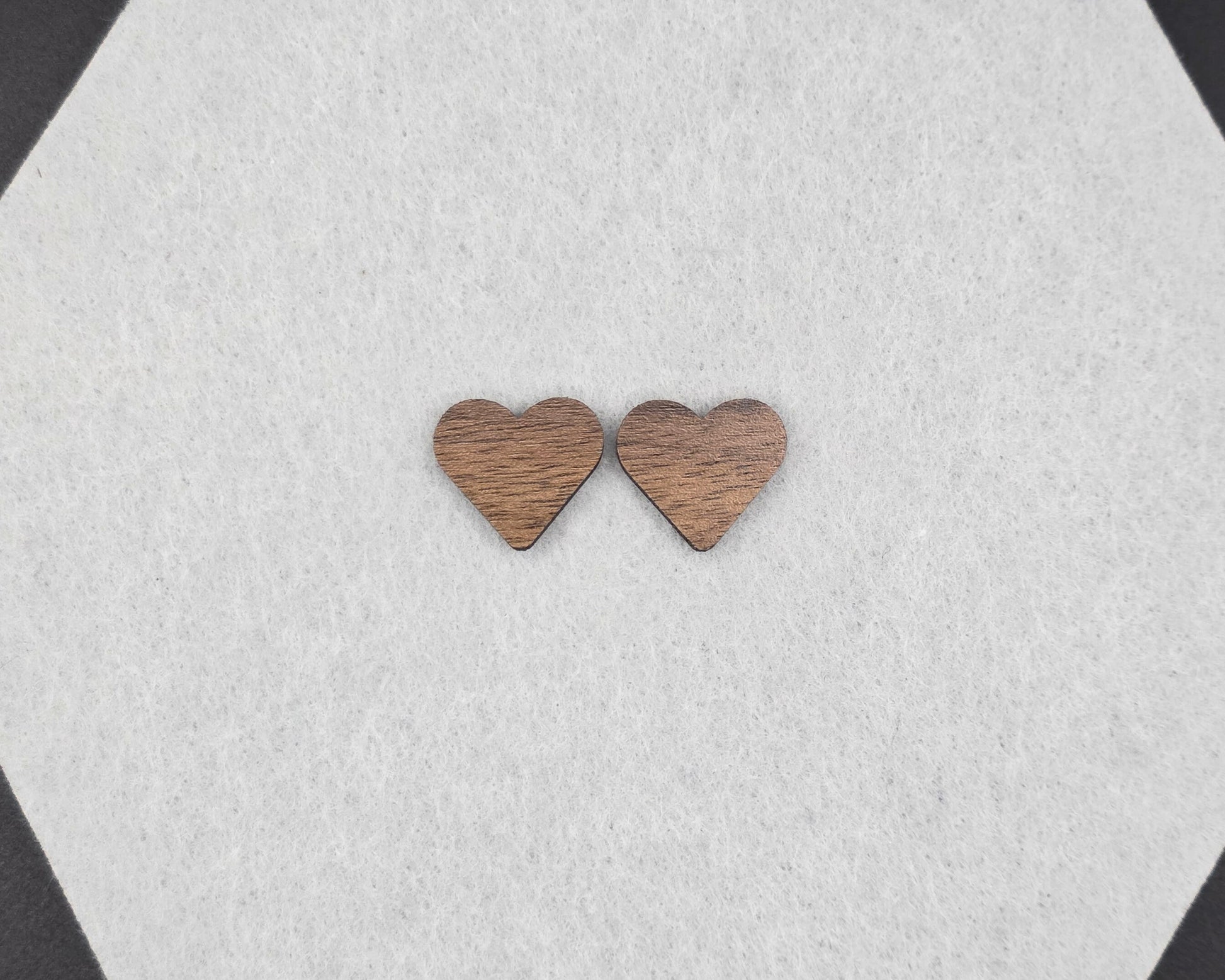 Walnut wood heart stud earrings on neutral felt, handmade by Rainbow Charlie