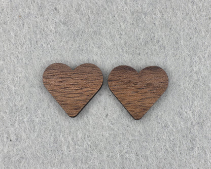 Close-up of walnut heart stud earrings showing wood grain texture, handmade wood earrings by Rainbow Charlie