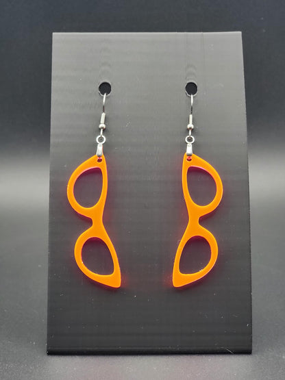 Fluorescent acrylic cat-eye glasses dangle earrings on a matte black jewelry card. Handmade, laser-cut retro jewelry.