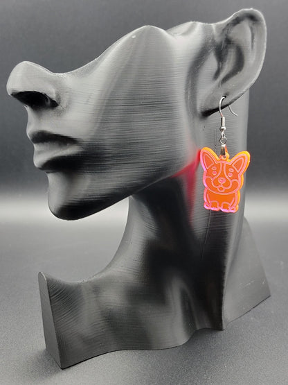 Fluorescent laser-cut acrylic corgi earring displayed on a black 3D printed mannequin. Lightweight dangle with stainless steel hook.