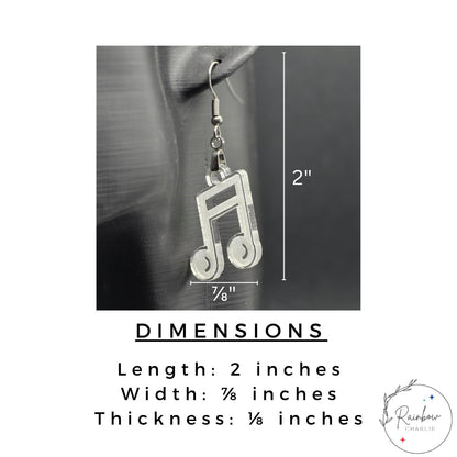 Close-up of a clear acrylic music note earring hanging from a mannequin ear. Text on the image displays the earring’s measurements: 2 inches long, ⅞ inch wide, and ⅛ inch thick. Clean, minimalist layout with logo at bottom right.