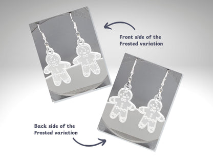 Two angled photos showing front and back sides of frosted acrylic gingerbread man earrings. The front image shows engraved cookie details; the back reveals smooth frosted finish. Text labels indicate “Front side” and “Back side of the Frosted variation.”
