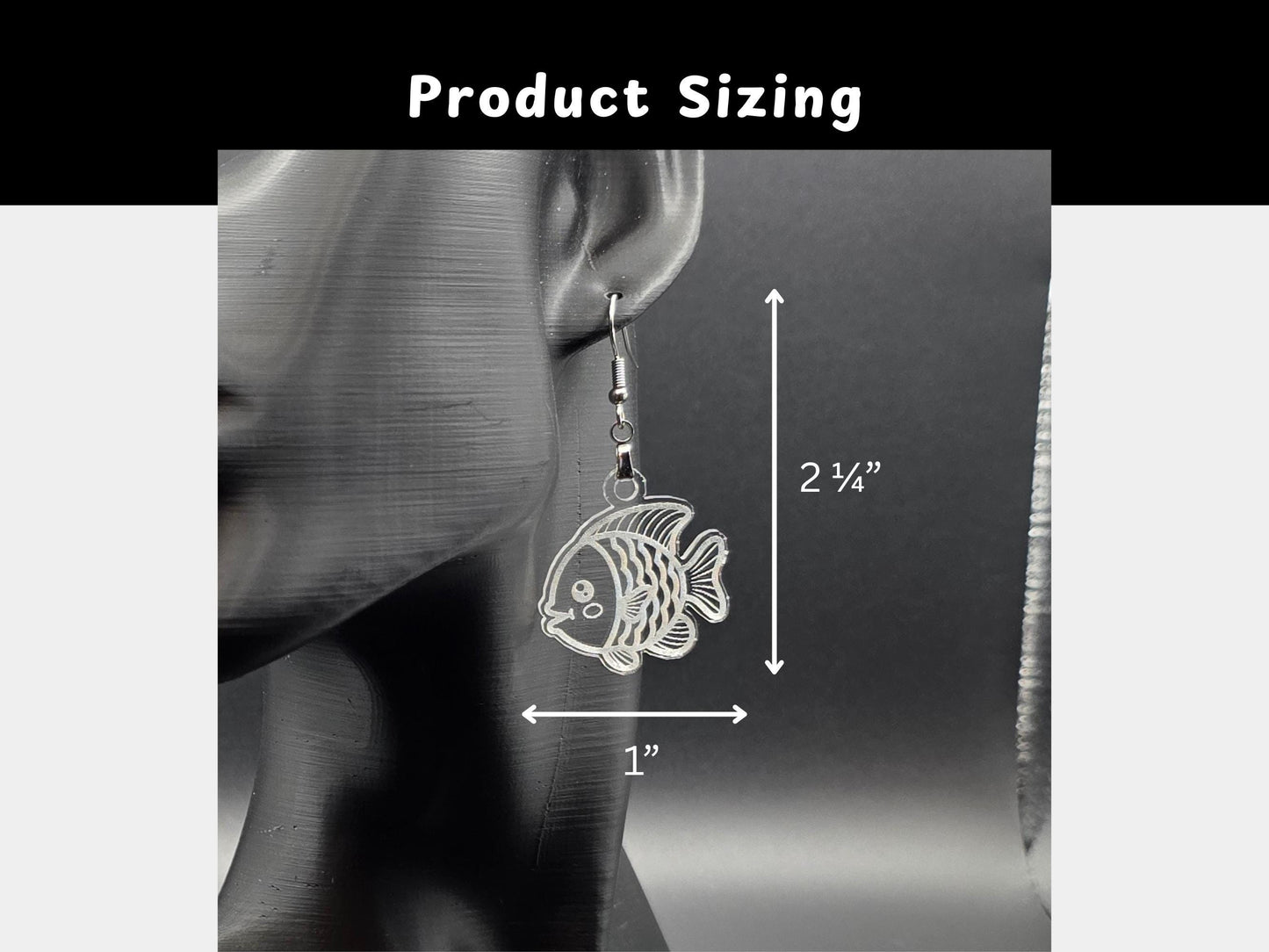 Size guide showing the clear acrylic goldfish earrings hanging on a black mannequin display. Measurement lines indicate the earrings are approximately 2¼ inches long and 1 inch wide.