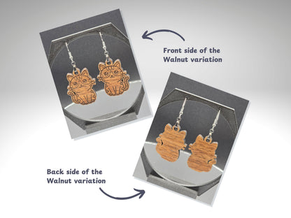 Front and back view of walnut wood cat earrings. The front side shows engraved cat details, while the back shows the natural wood grain without engraving. Text labels and arrows indicate the front and back sides.